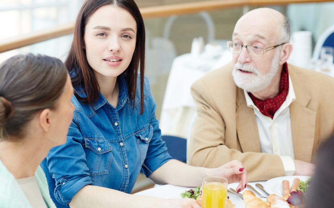 family-enjoying-food-and-conversation-at-table